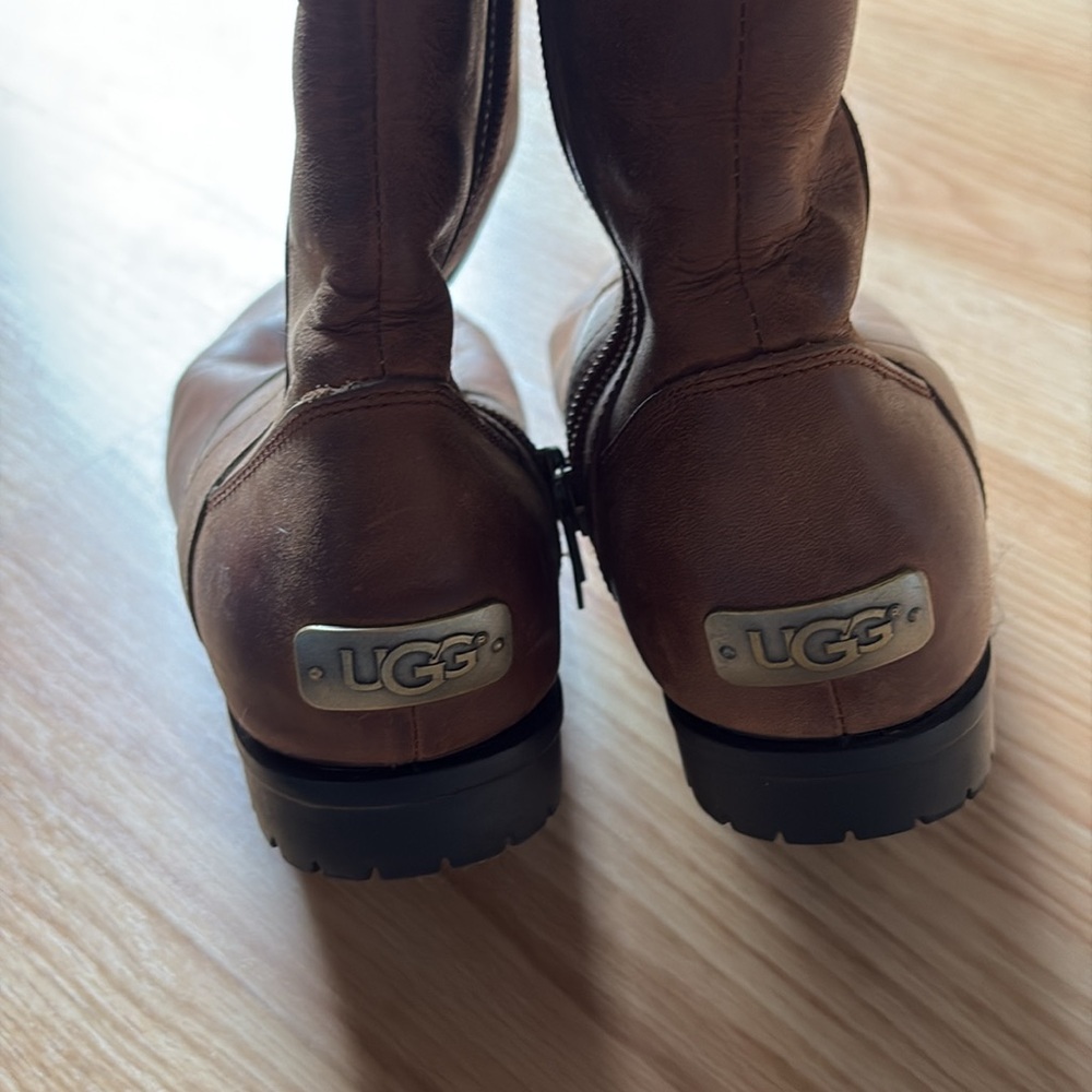 Used UGG leather zip boots with metal embellishment logo in back